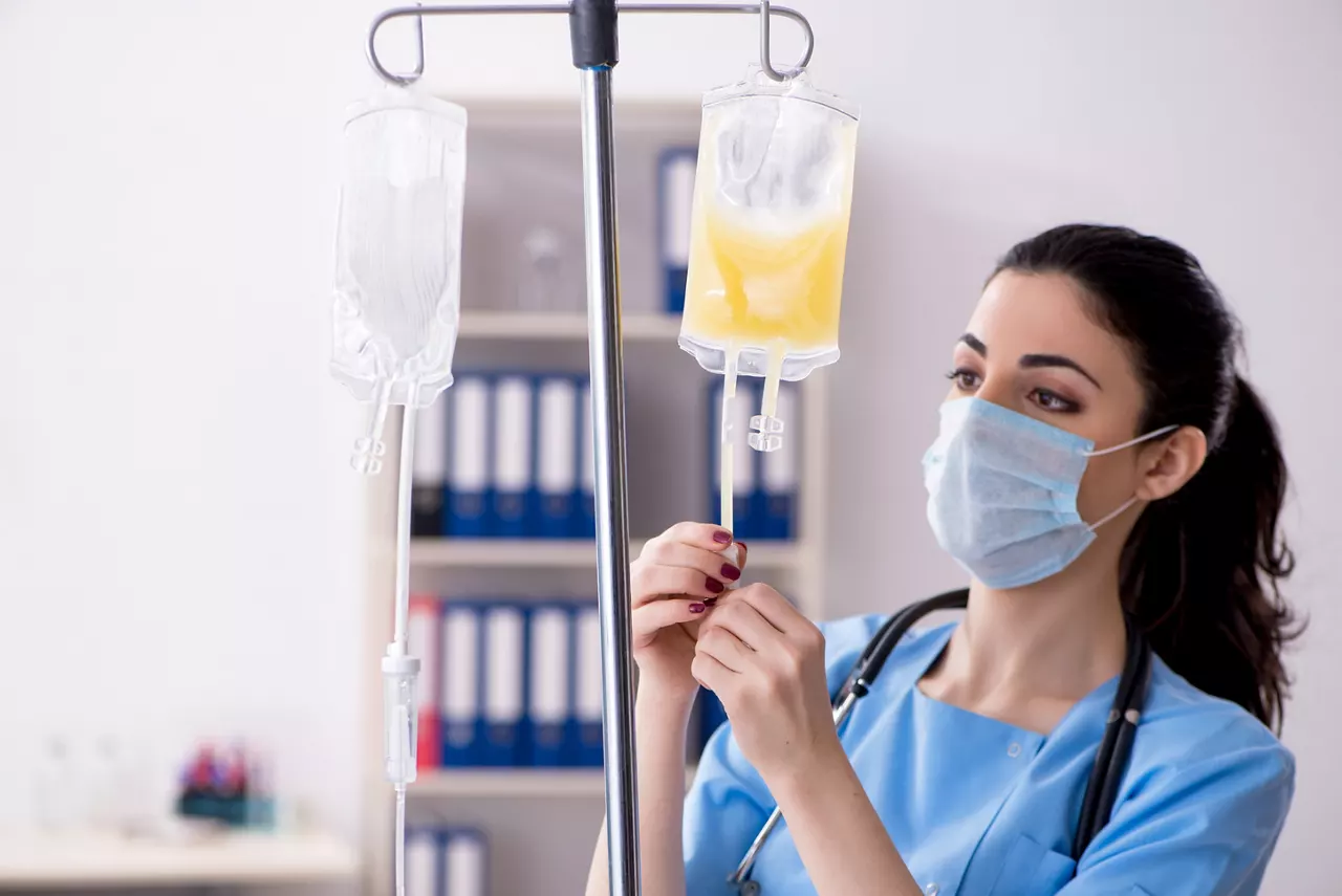Young female doctor in infusion concept