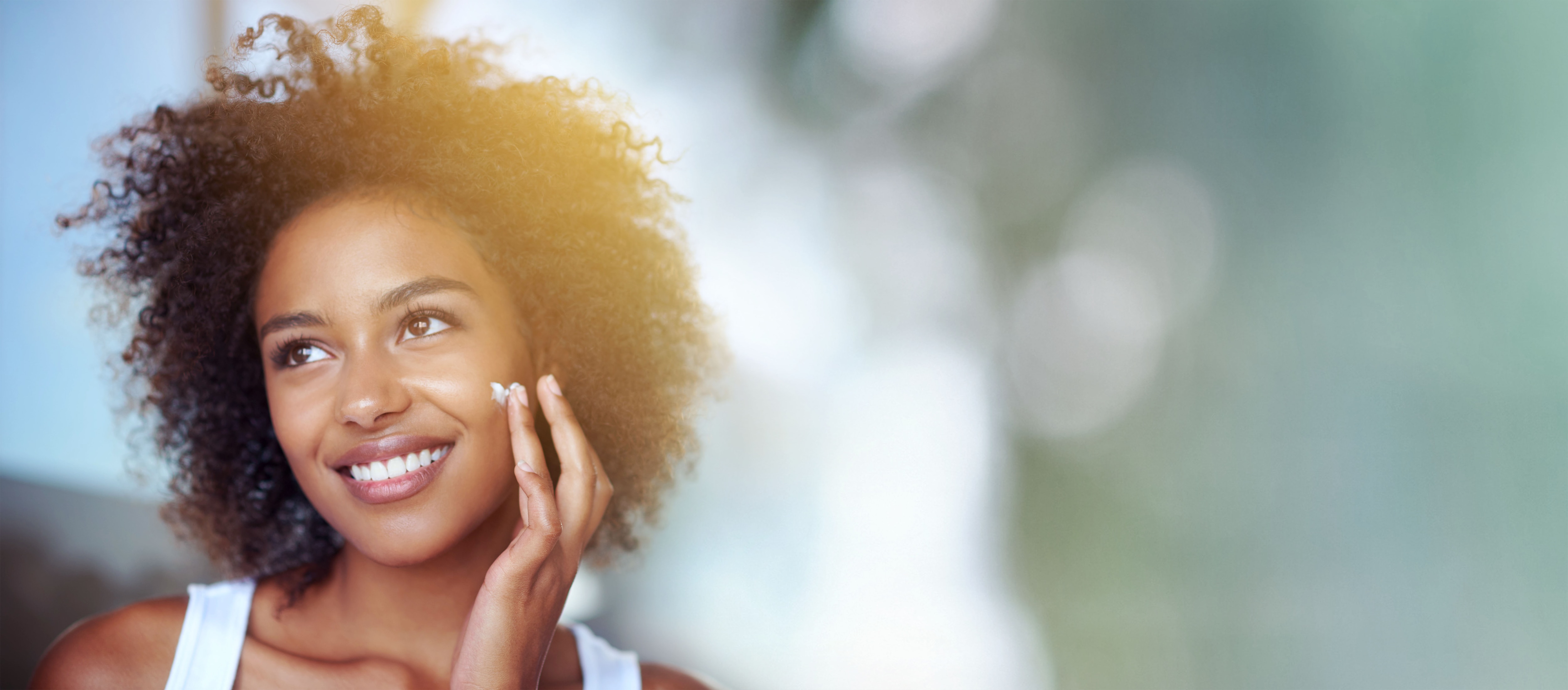 Skincare, beauty cream and face of black woman with mockup for wellness, facial treatment and cosmetics. Dermatology, healthy skin and happy girl with spf creme, lotion and moisturizer in bathroom.