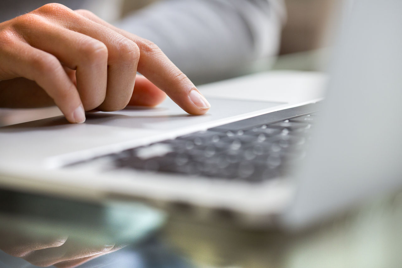 Person using laptop mouse pad with index finger; Shutterstock ID 147185228