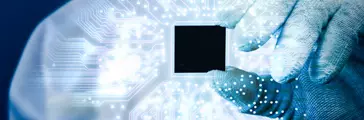 Engineer holding electronics chip and electronics
